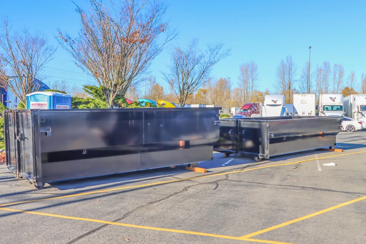 Professional dumpster rental service with roll-off container on residential driveway in Harlingen